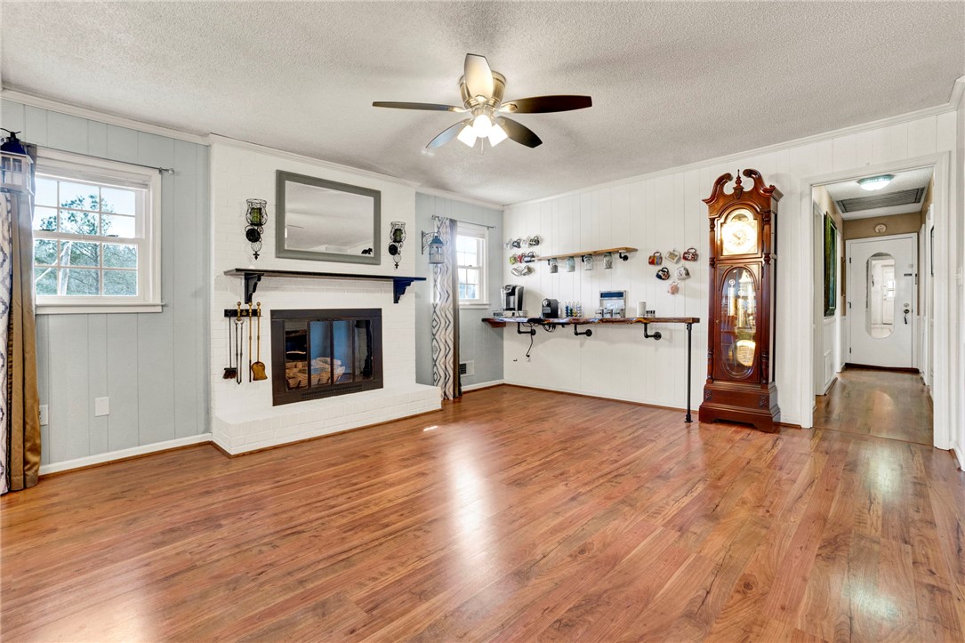 133 Old Liberty Pickens Road Pickens, SC 29671 - Photo 8 of 48 This inviting living area boasts rich hardwood flooring and a classic fireplace, perfect for gatherings.