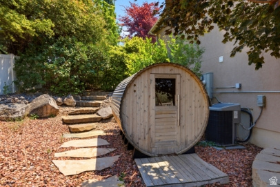 722 West Webb Circle, Unit 2 Draper, UT 84020 - Photo 33 of 39 Barrel sauna with a wood-plank entry, set amidst a landscaped area with natural stone steps and mature plantings