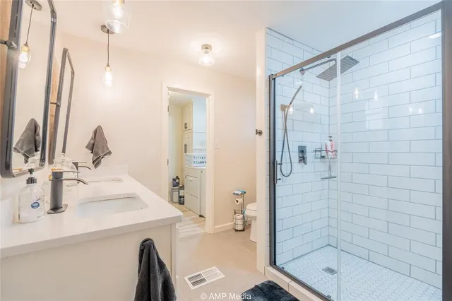 a bathroom with a shower sink and mirror