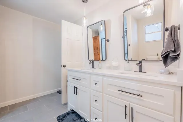 a bathroom with double sink and a mirror