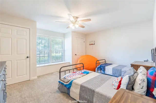 a bedroom with two beds and a window