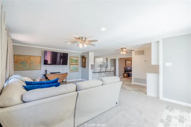a living room with furniture and kitchen view