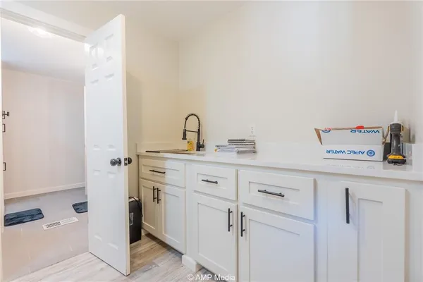 a utility room with multiple dryer and washer