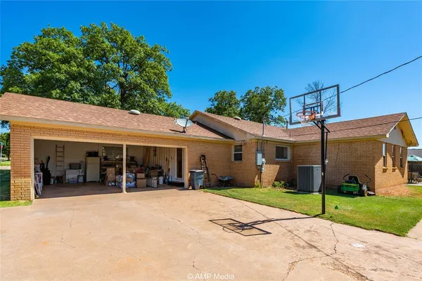 a view of a house with a patio and a yard