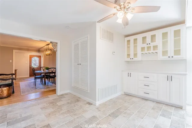 a view of a livingroom with furniture and chandelier fan