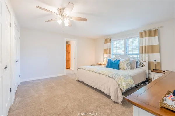 a bedroom with bed and window