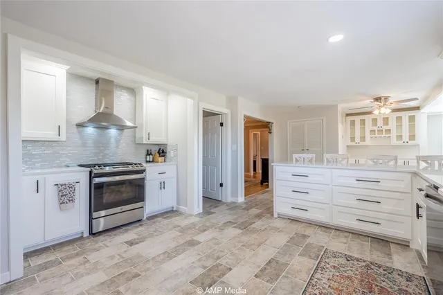 a kitchen with granite countertop a stove and a sink