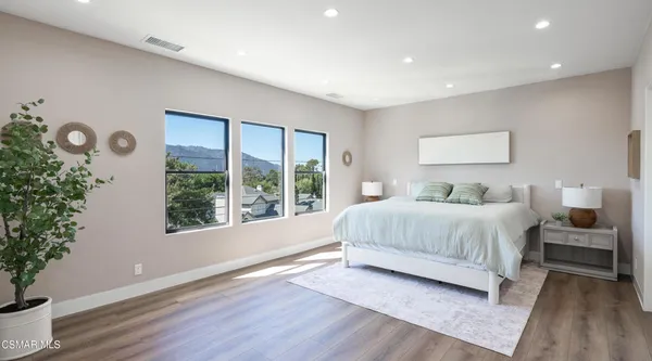 a bedroom with a bed and a painting