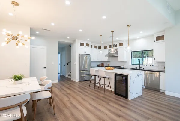 a view of a dining room with furniture and wooden floor