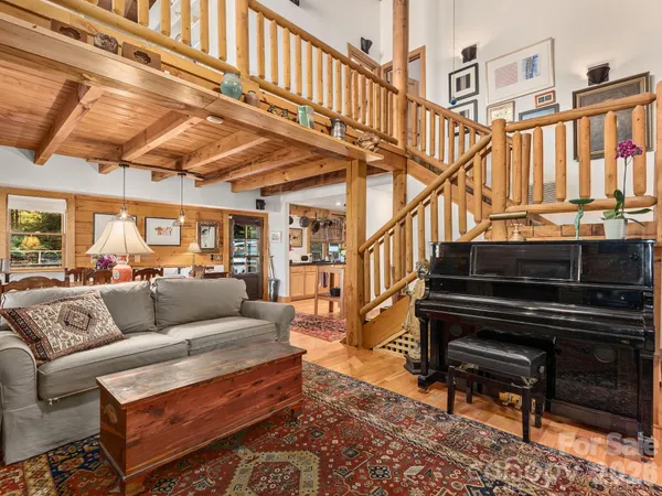 a living room with furniture and a book shelf