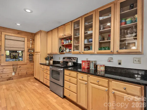 a kitchen with stainless steel appliances granite countertop a stove and cabinets