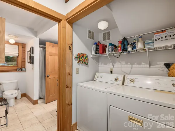 a bedroom with a bed next to a window