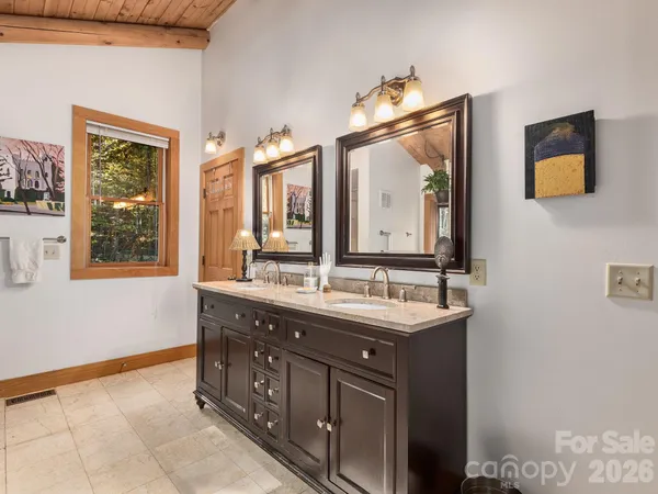 a view of a workspace with furniture and a large window