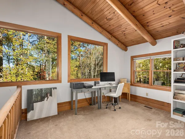 a room with book shelf and a window