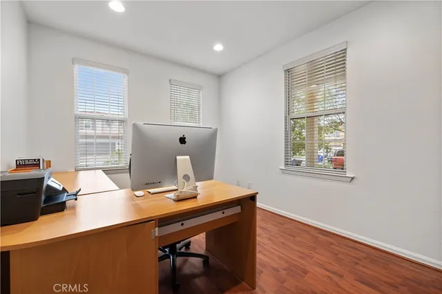 a view of a chair and table in backyard of the house
