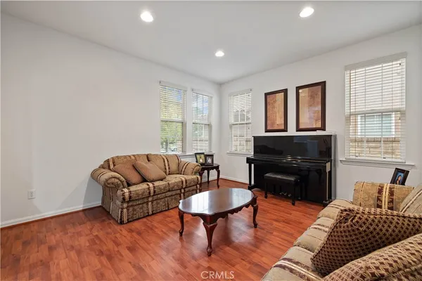 a kitchen with granite countertop stainless steel appliances a table and chairs in it