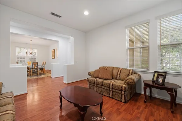 a kitchen with kitchen island granite countertop wooden cabinets a refrigerator and a sink