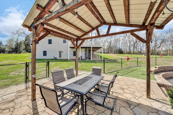 a view of field with trees in the background