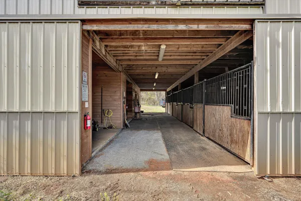 a view of a yard with wooden fence