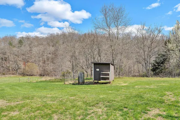 a view of a house with yard and sitting area