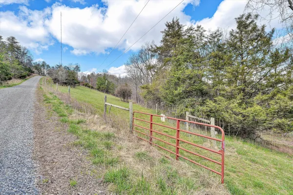 a view of a balcony with wooden floor and fence