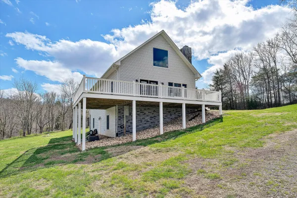 a view with granite countertop a sink and a stove with wooden floor