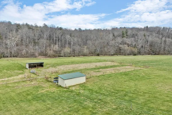 a view of a balcony with wooden floor & fence