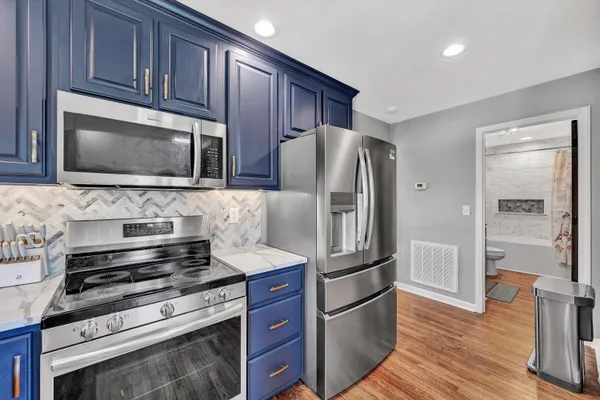 a view of entryway and hall with wooden floor