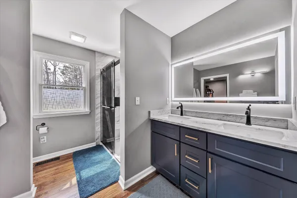a bathroom with a toilet sink and mirror