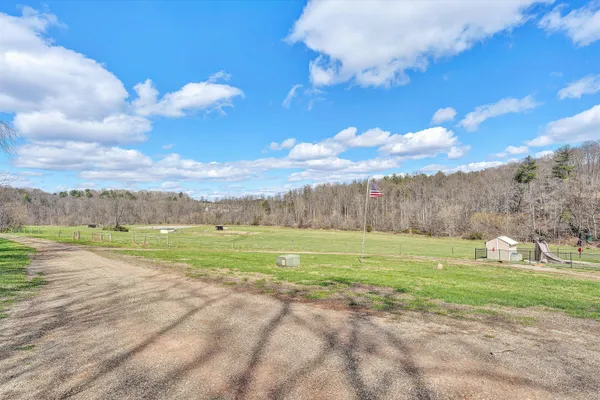 a view of a chairs and table in the patio with a backyard