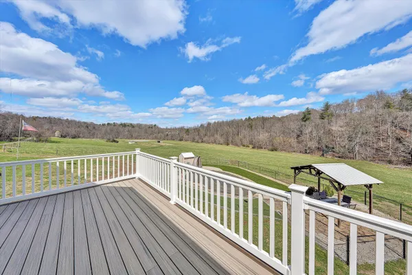 a view of a field with trees in the background