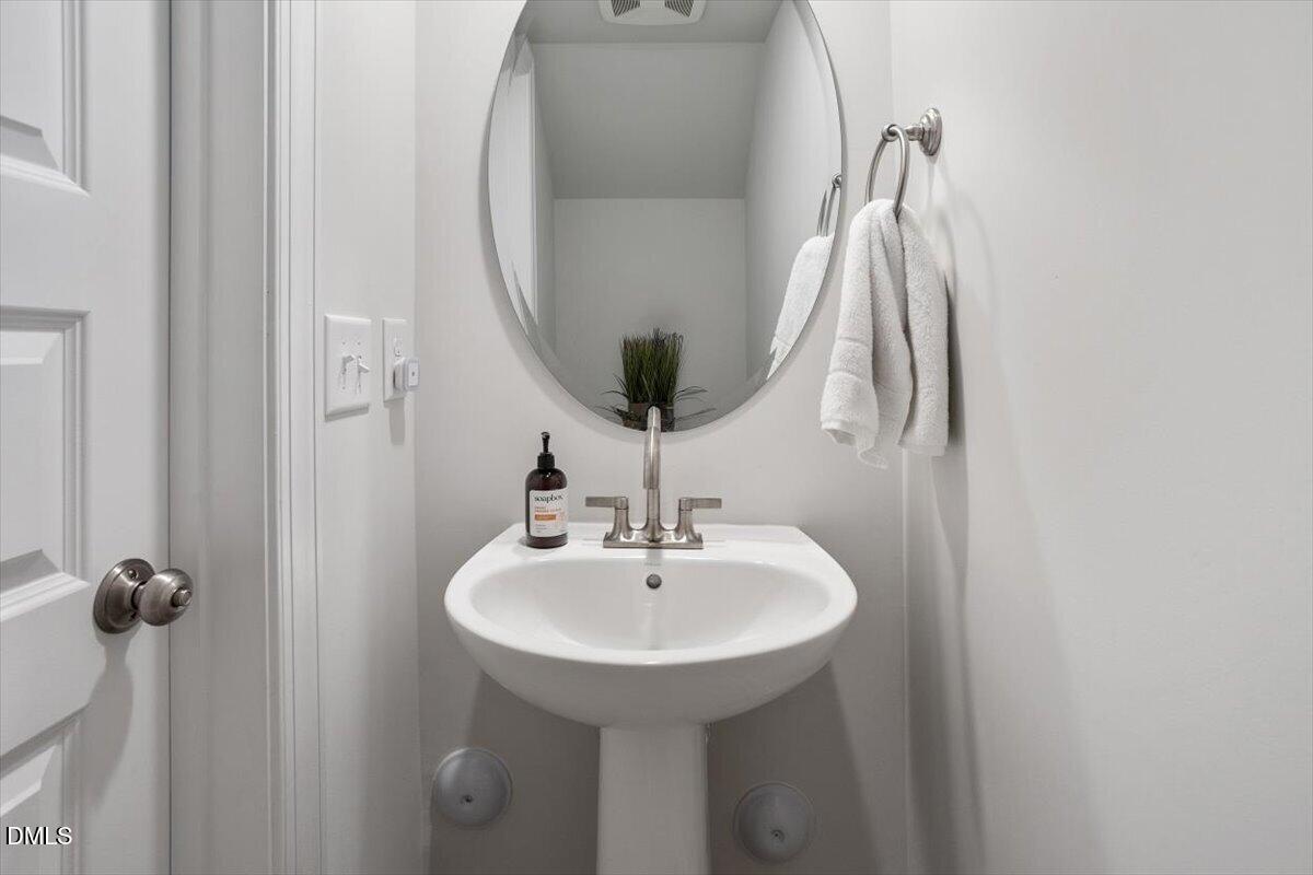 1234 Coach Sta Alley, Unit 101 Raleigh, NC 27601 - Photo 14 of 30 a bathroom with a sink and a mirror