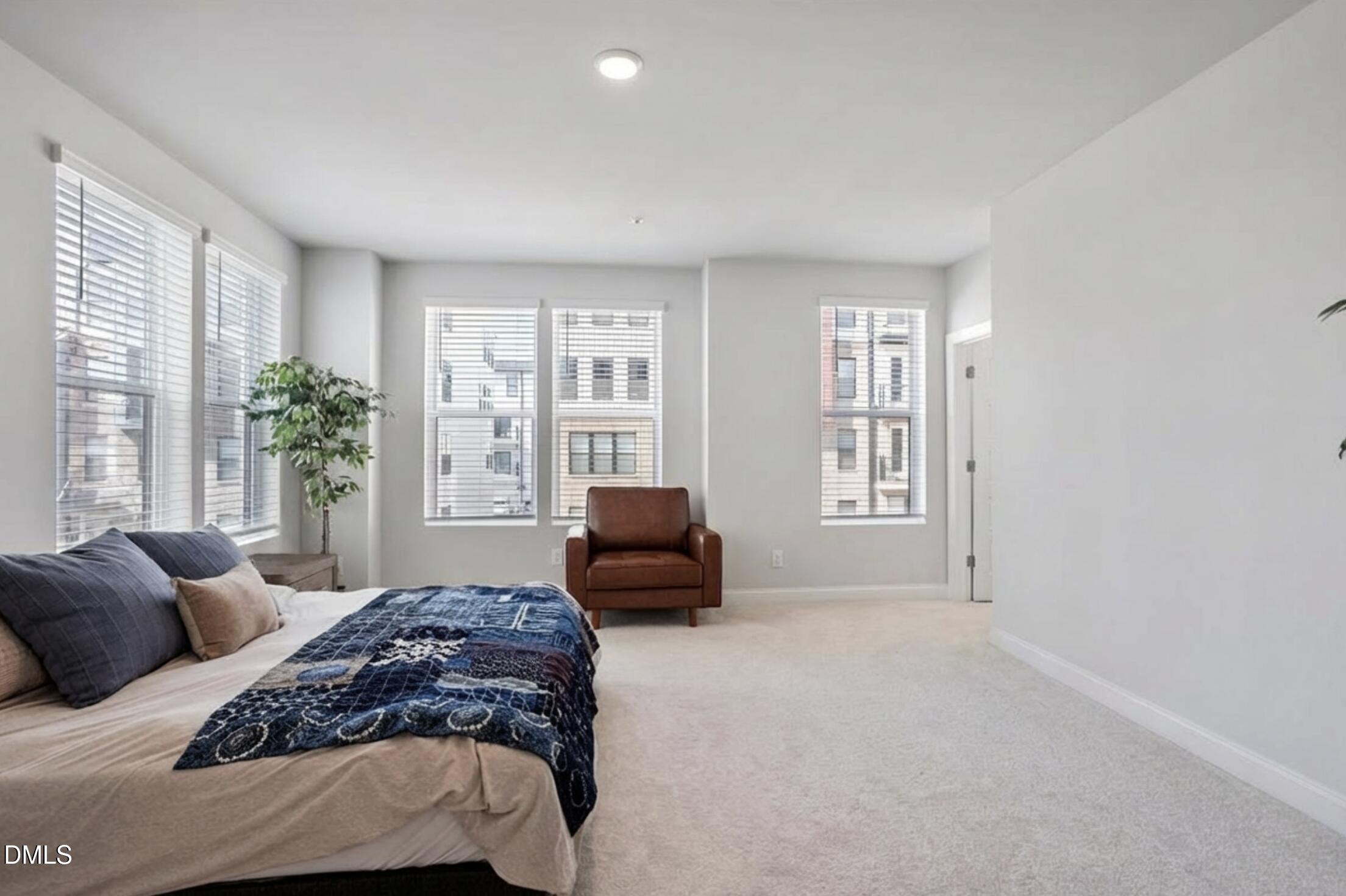 1234 Coach Sta Alley, Unit 101 Raleigh, NC 27601 - Photo 16 of 30 a bedroom with a bed and a couch next to a window