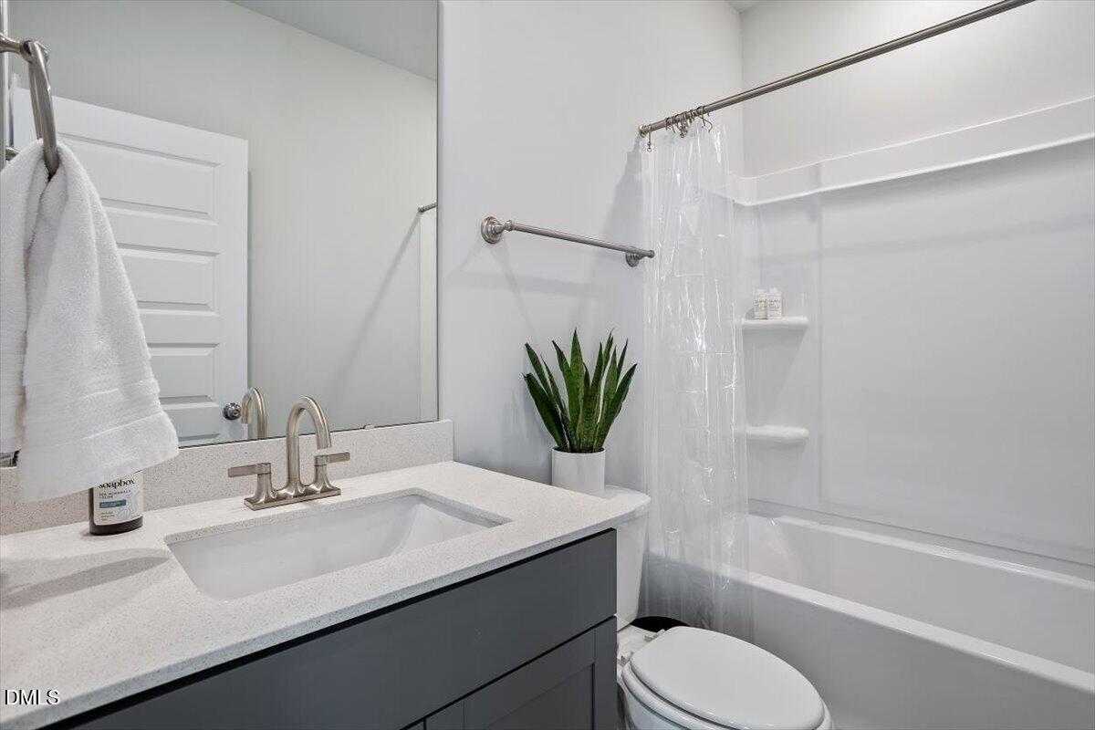 1234 Coach Sta Alley, Unit 101 Raleigh, NC 27601 - Photo 22 of 30 a bathroom with a sink toilet and shower
