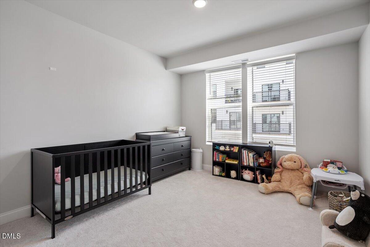 1234 Coach Sta Alley, Unit 101 Raleigh, NC 27601 - Photo 23 of 30 a bedroom with furniture and a window
