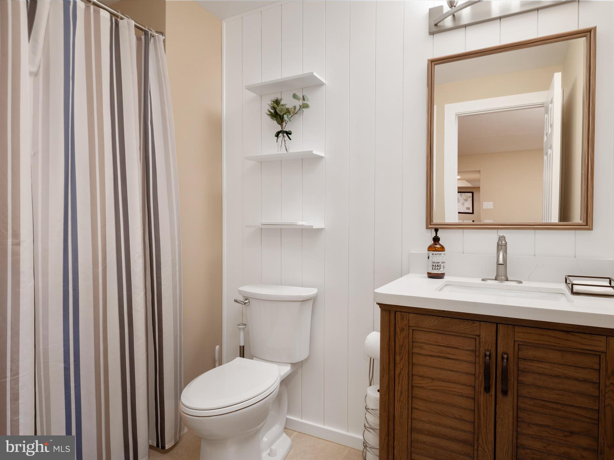 2322 Golden Chapel Road Odenton, MD 21113 - Photo 42 of 64 a bathroom with a toilet a sink and mirror