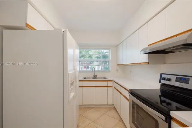 a utility room with sink dryer and washer