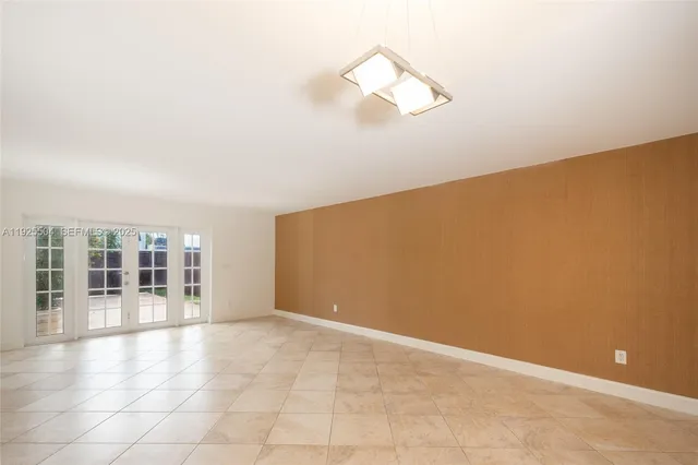 an empty room with windows and entrance