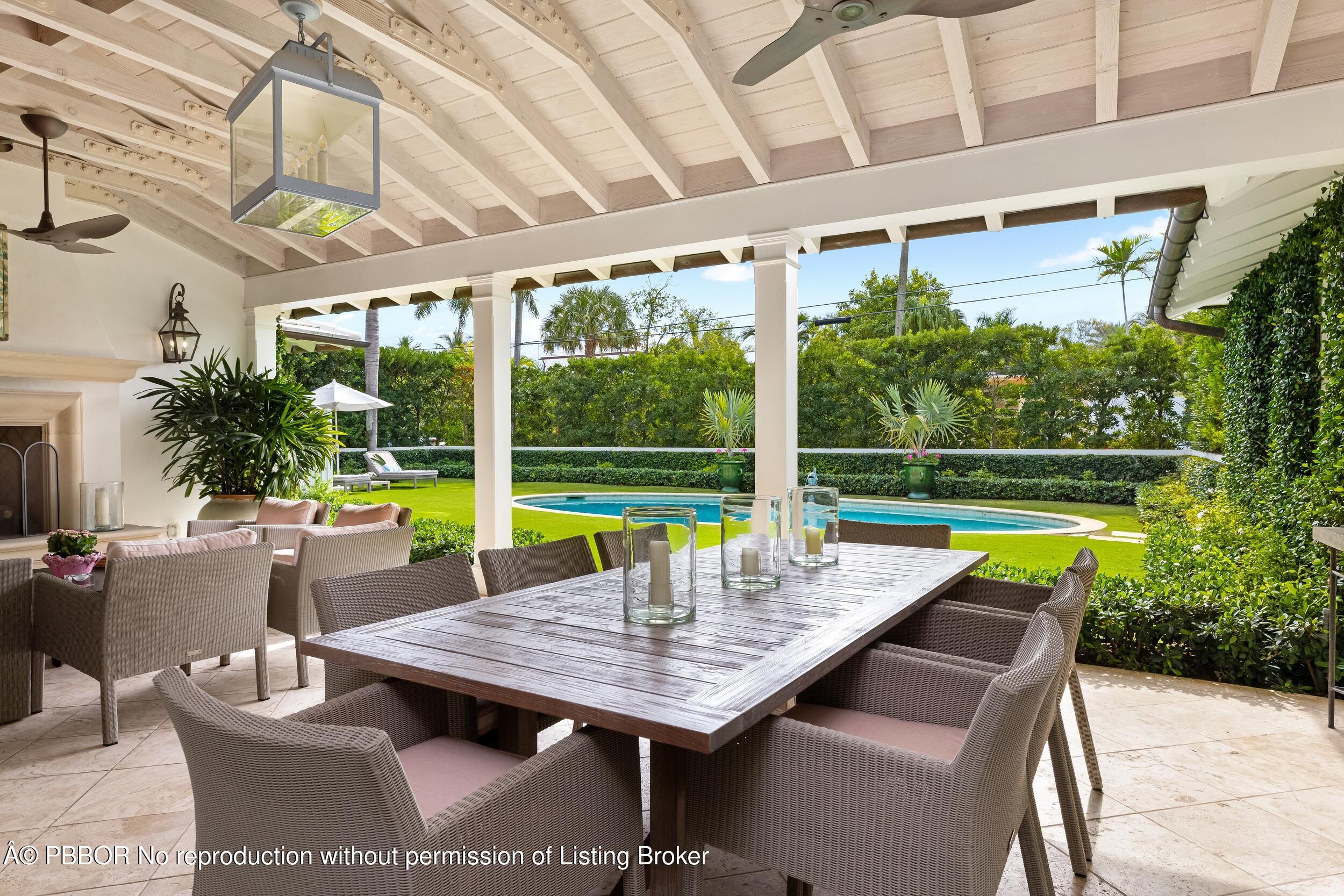 258 List Road Palm Beach, FL 33480 - Photo 35 of 45 a view of swimming pool with a table and chairs in patio