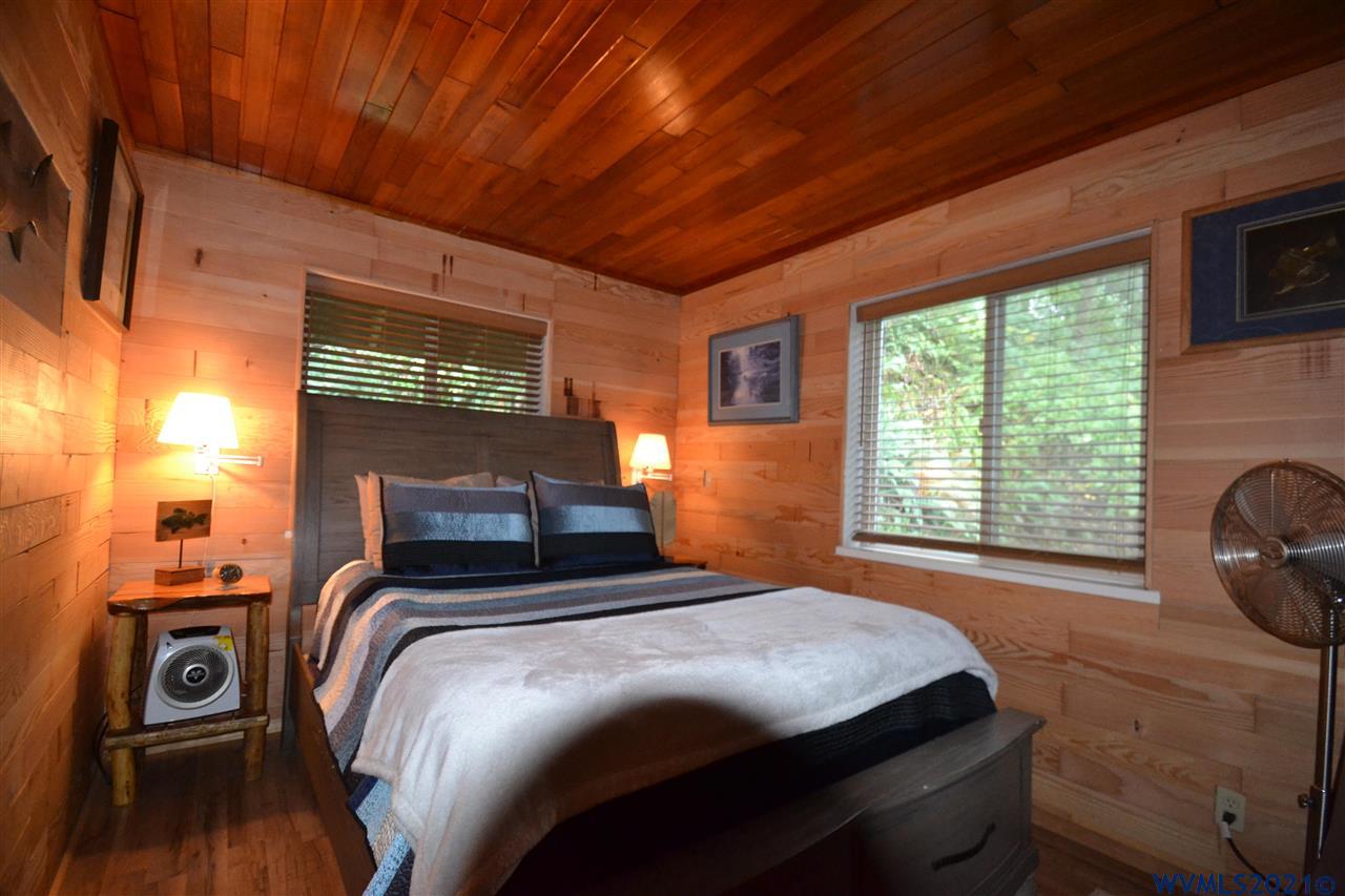 1690 Bayocean Road Northwest Tillamook, OR 97141 - Photo 14 of 25 a bedroom with a bed a dresser next to a window