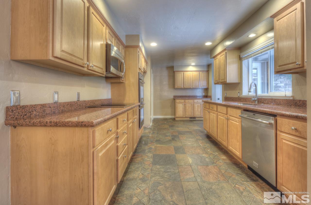 1635 Marla Drive Reno, NV 89509 - Photo 7 of 25 a kitchen with stainless steel appliances granite countertop a sink and cabinets