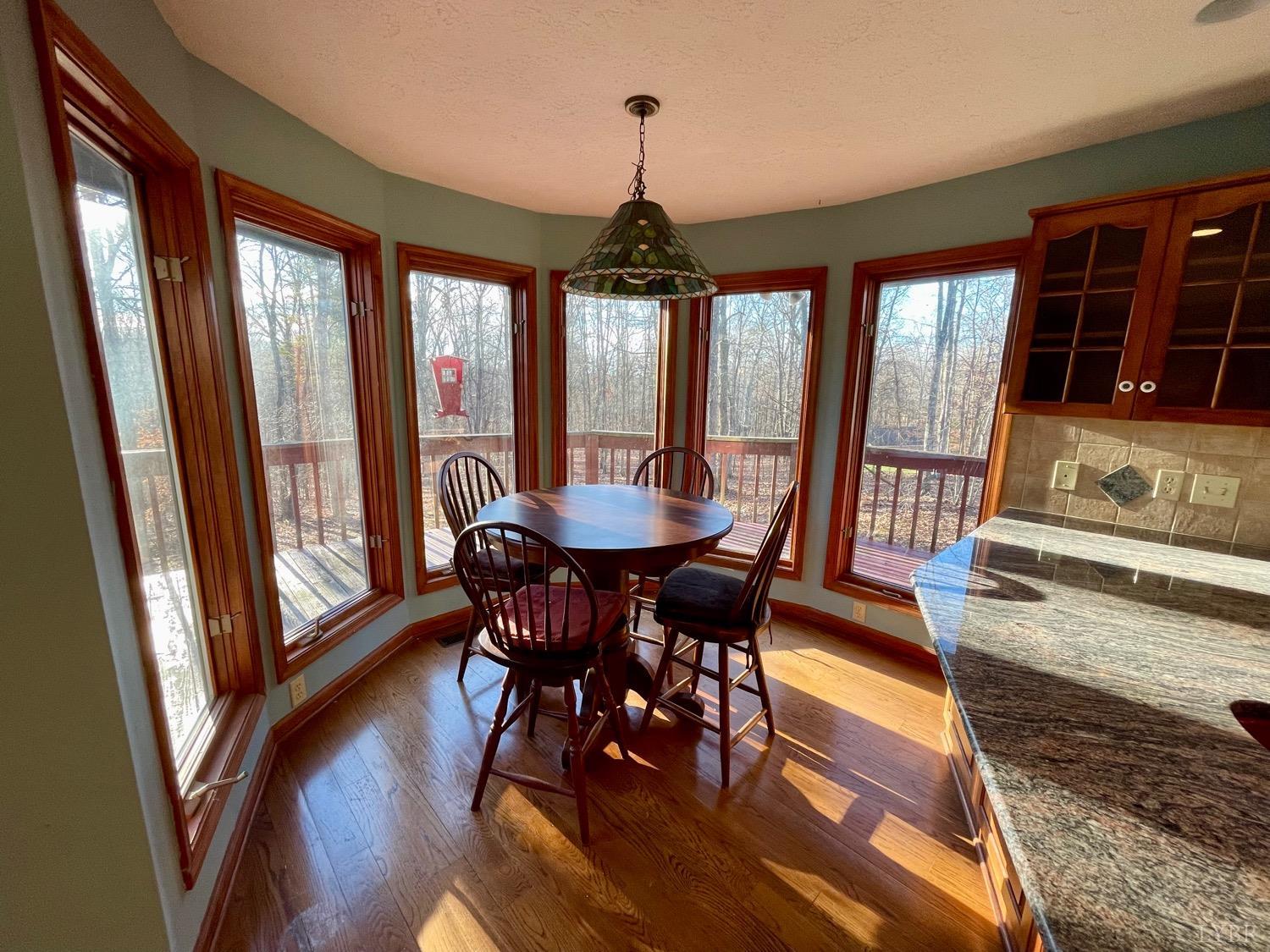 1739 Old Cifax Road Goode, VA 24556 - Photo 15 of 52 a view of a dining room with furniture window and wooden floor