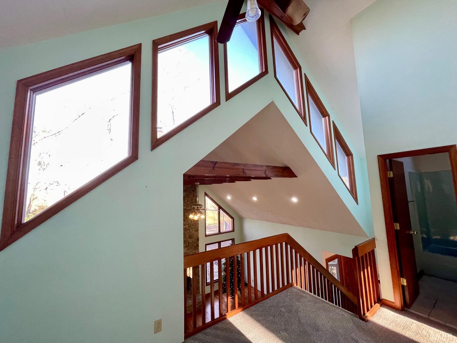 1739 Old Cifax Road Goode, VA 24556 - Photo 29 of 52 a view of staircase with lots of frames on wall and a window