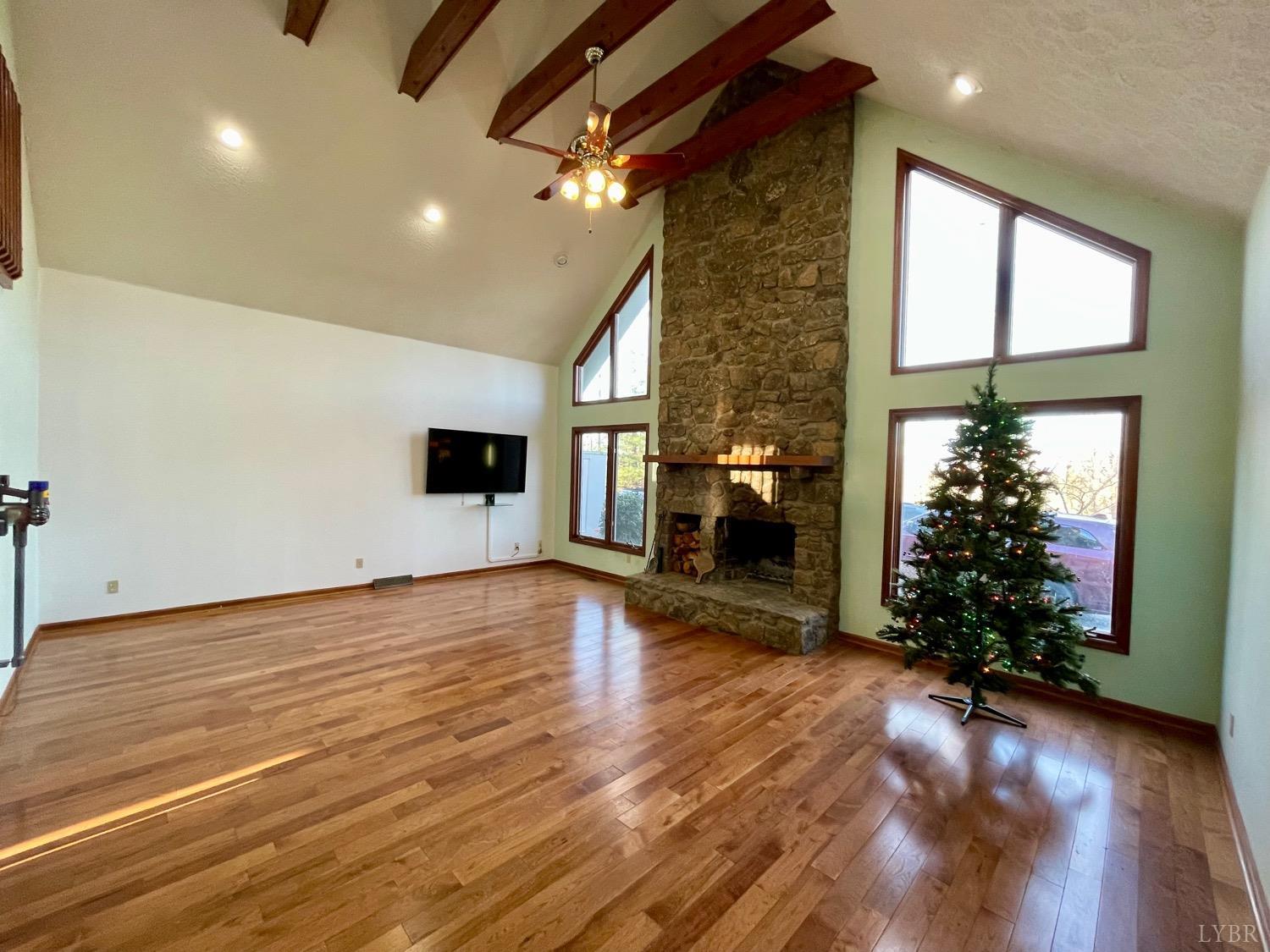 1739 Old Cifax Road Goode, VA 24556 - Photo 5 of 52 a view of a livingroom with wooden floor a ceiling fan and window