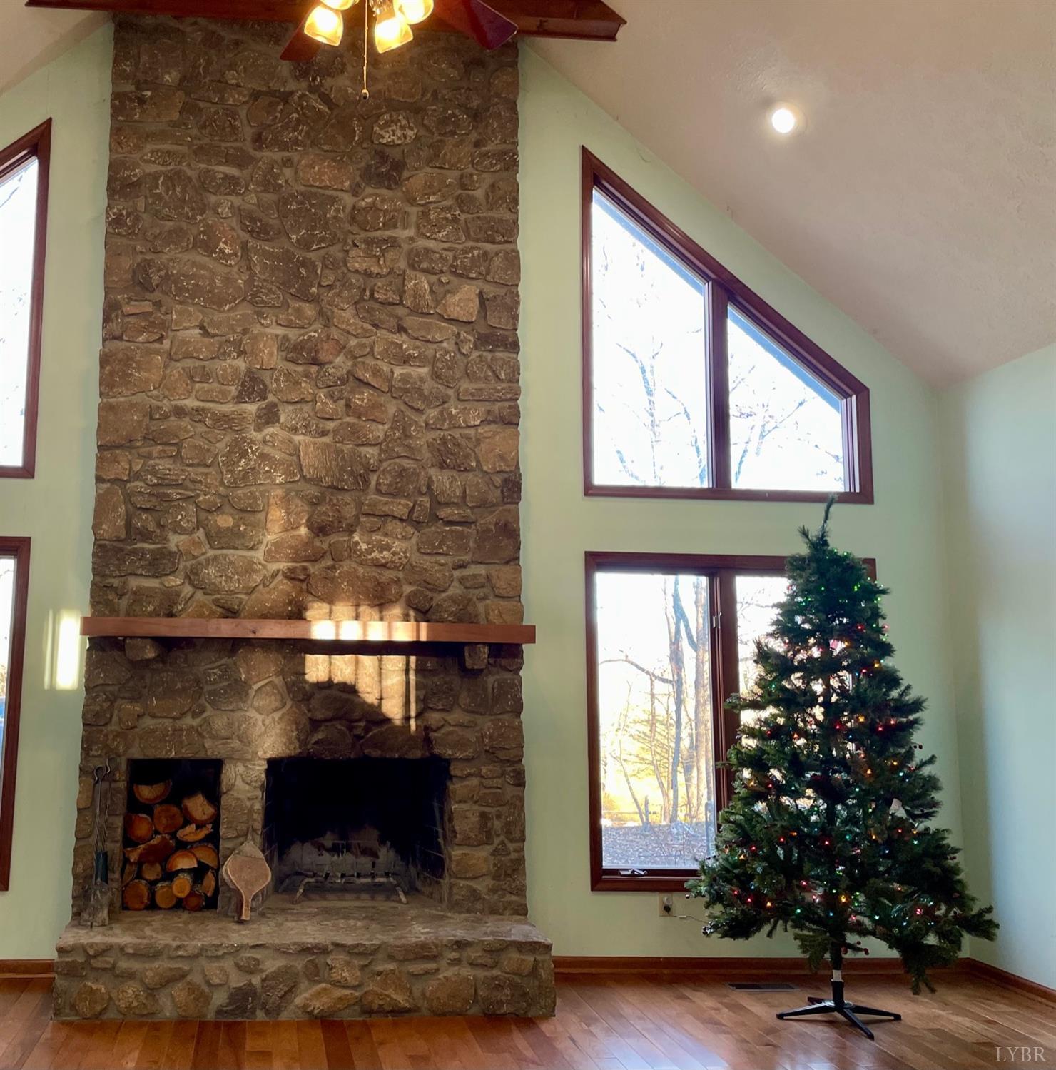 1739 Old Cifax Road Goode, VA 24556 - Photo 6 of 52 a living room with a fireplace and wooden floor