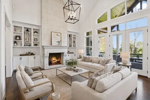 a living room with furniture a fireplace and a large window