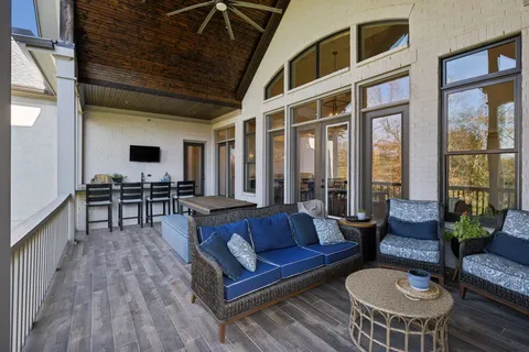 a kitchen with stainless steel appliances a dining table chairs and wooden floor