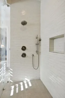a bathroom with a bathtub and a shower