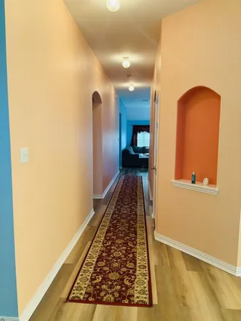 a view of hallway with wooden floor