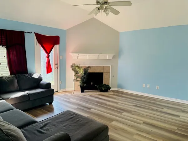 a living room with furniture and a fireplace